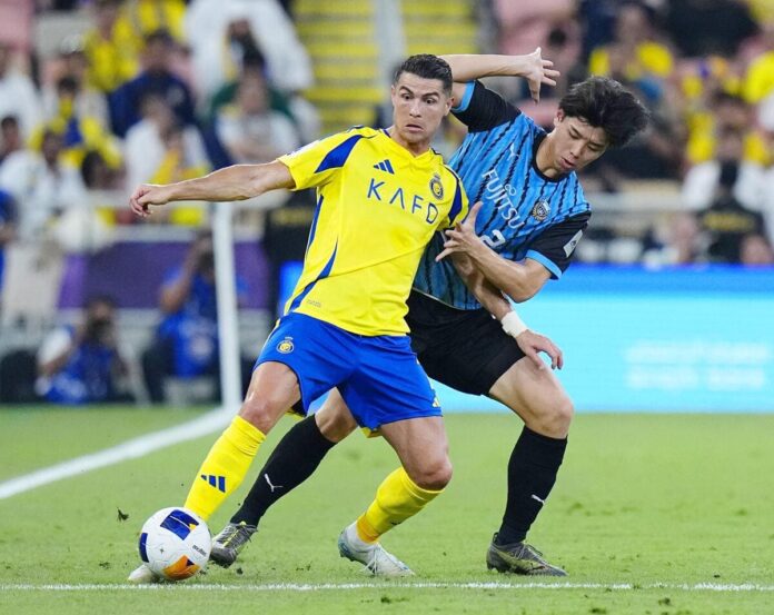 Tottenham new-boy Kota Takai tussles with Cristiano Ronaldo